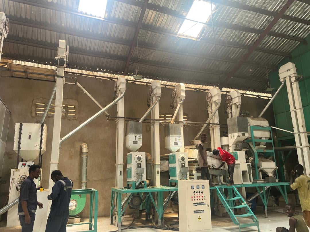 Workers operating rice milling equipment at GT Rice Mills